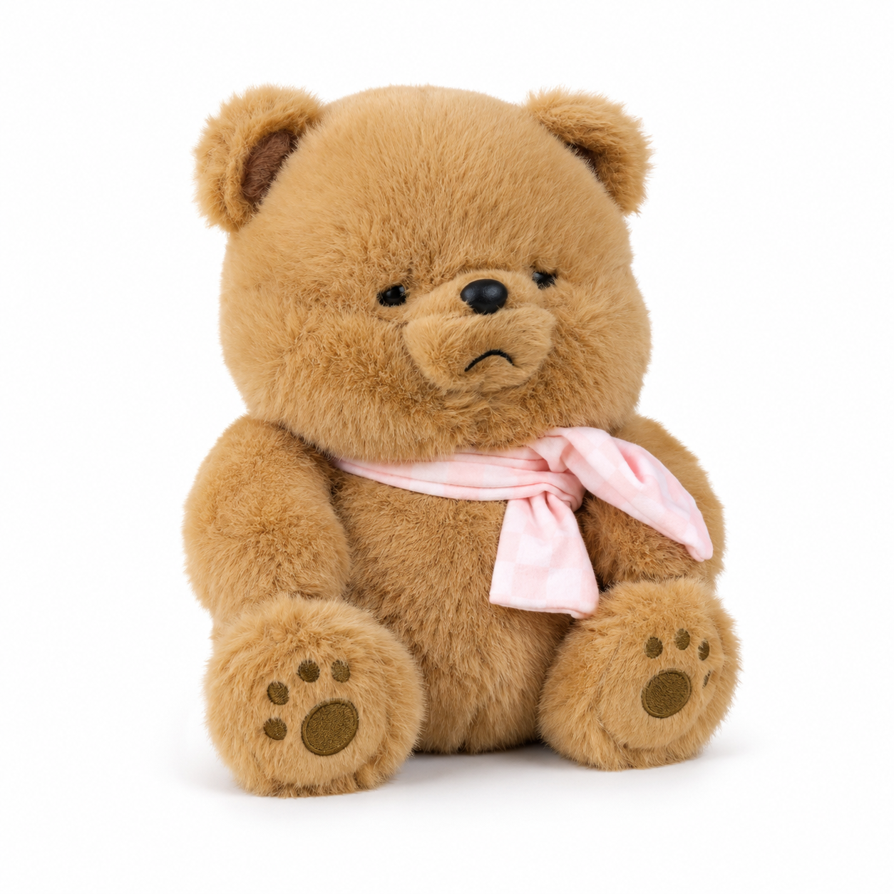 Fluffy brown teddy bear with pink bow scarf, studio photo